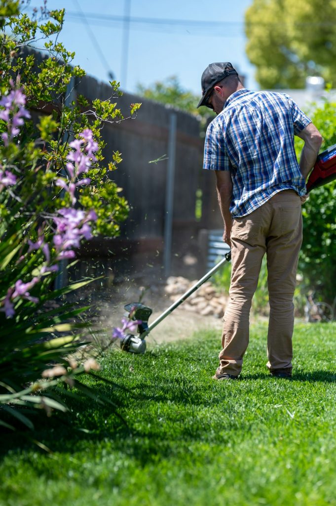 Man edging a lawn with a weed eater